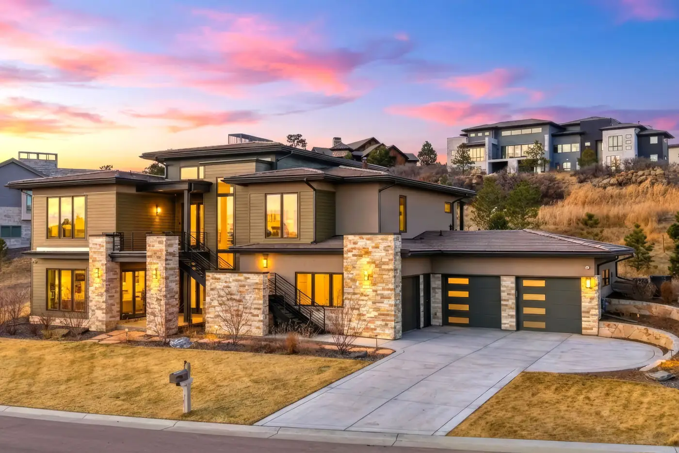 Modern stone home at twilight, photographed by ShotEstate