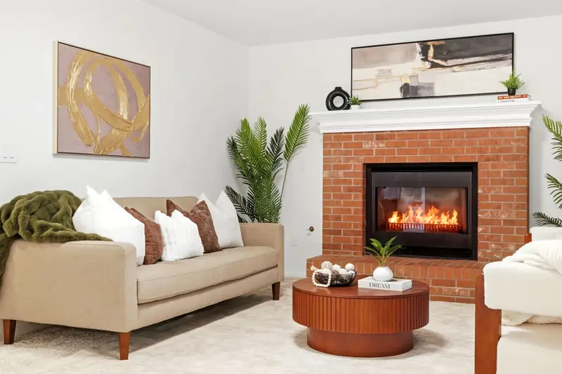 Staged living room with a brick fireplace