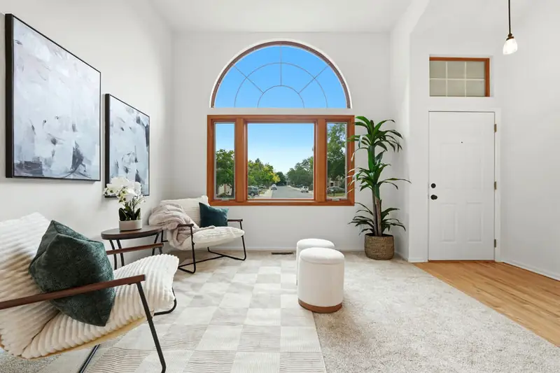 Staged living room under an arched window