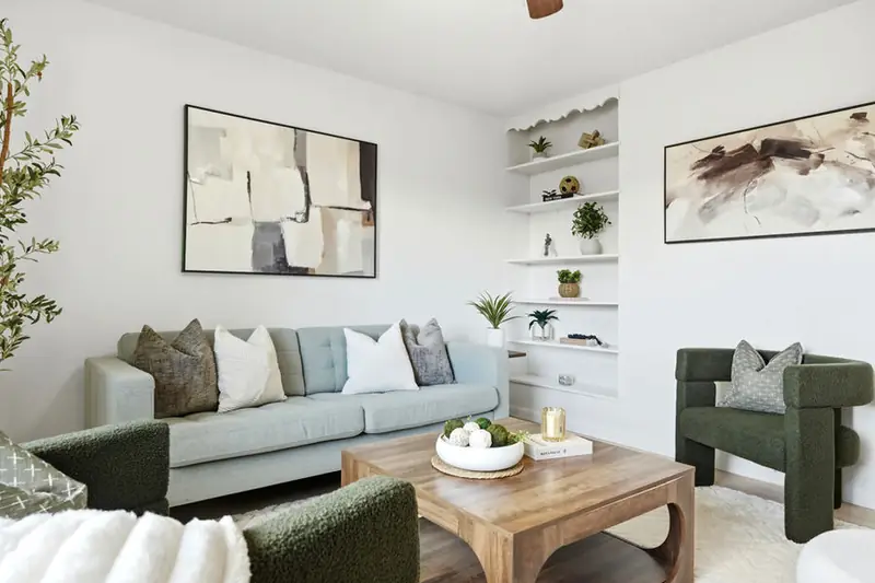 Staged living room with green armchairs